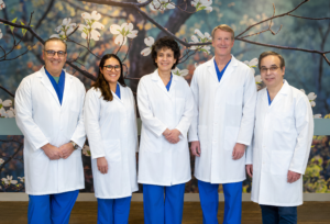 five Emerson Health gastroenterologists standing in a row, smiling.