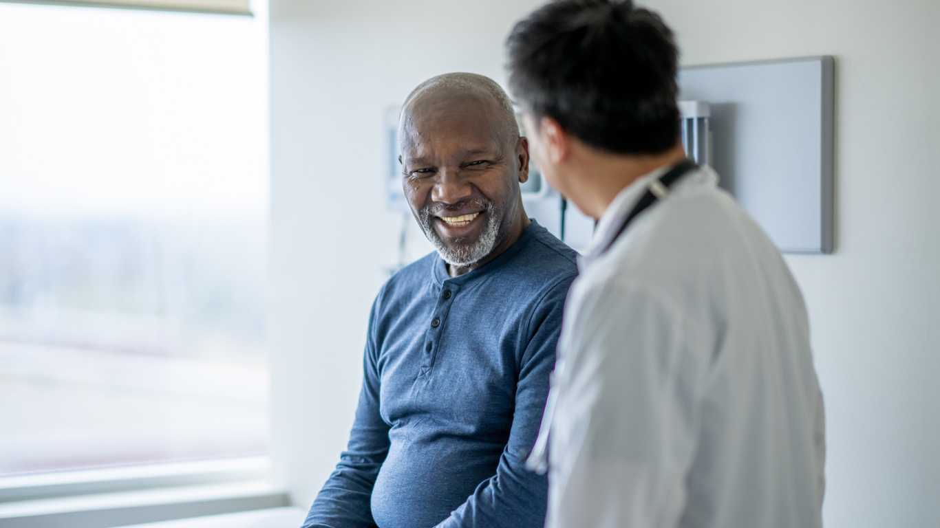 a man smiling at a doctor
