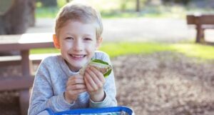 a boy eating a sandwich