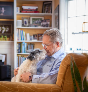 George Peabody with his dog on the couch