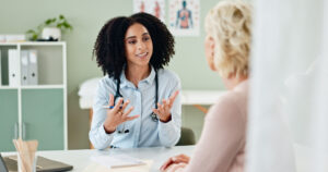 A female doctor conducting a consultation with a female patient.