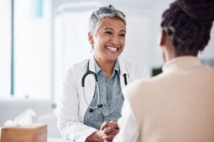 A smiling doctor consulting a patient.