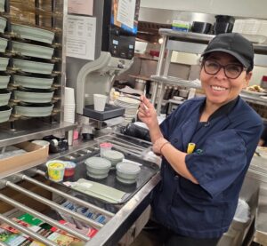 Smiling woman in food service area