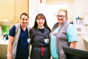 Three medical assistants smiling together