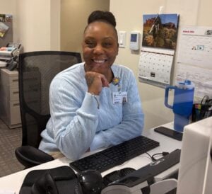 Smiling woman at an office desk.
