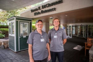 Two men standing at entrance.