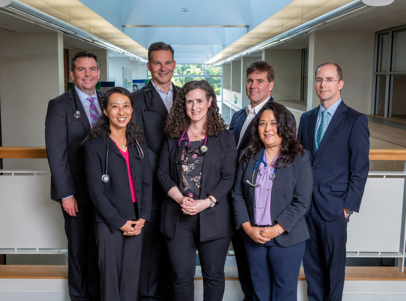 Group photo of providers at Emerson Health Cardiology, with three women standing in the front and four men standing in the back, all in suits and some wearing stethoscopes