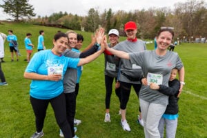 6 ICU Teammates giving a group "High-Five" after the run